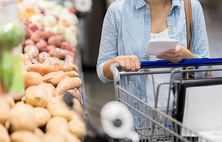 Lady with shopping cart at the grocery store